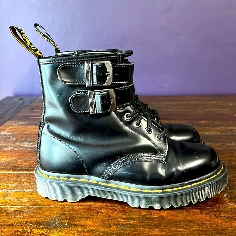 Doc Martens combat boots with double buckles.